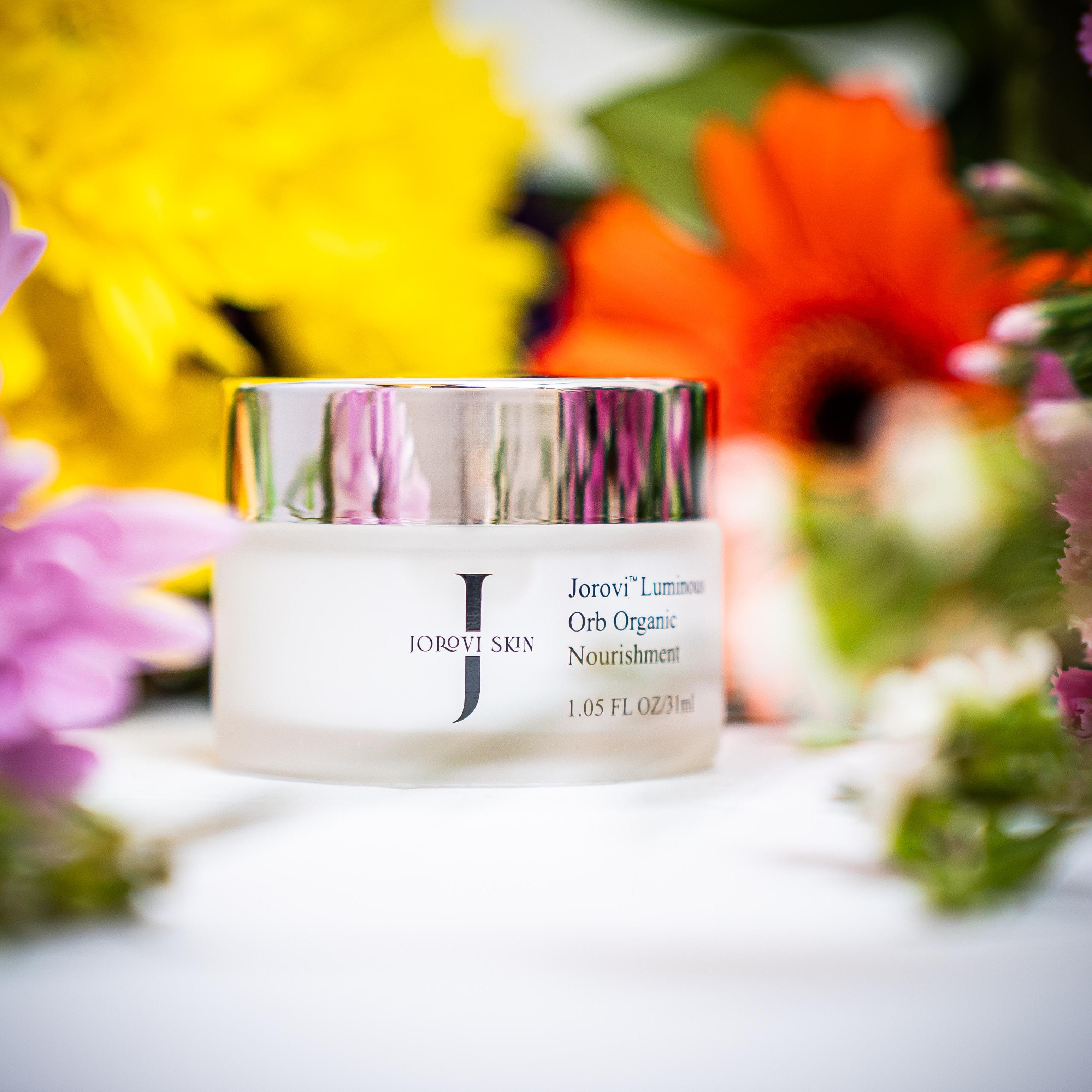 Cosmetic jar with colorful flowers in the background jorovi skin eye cream