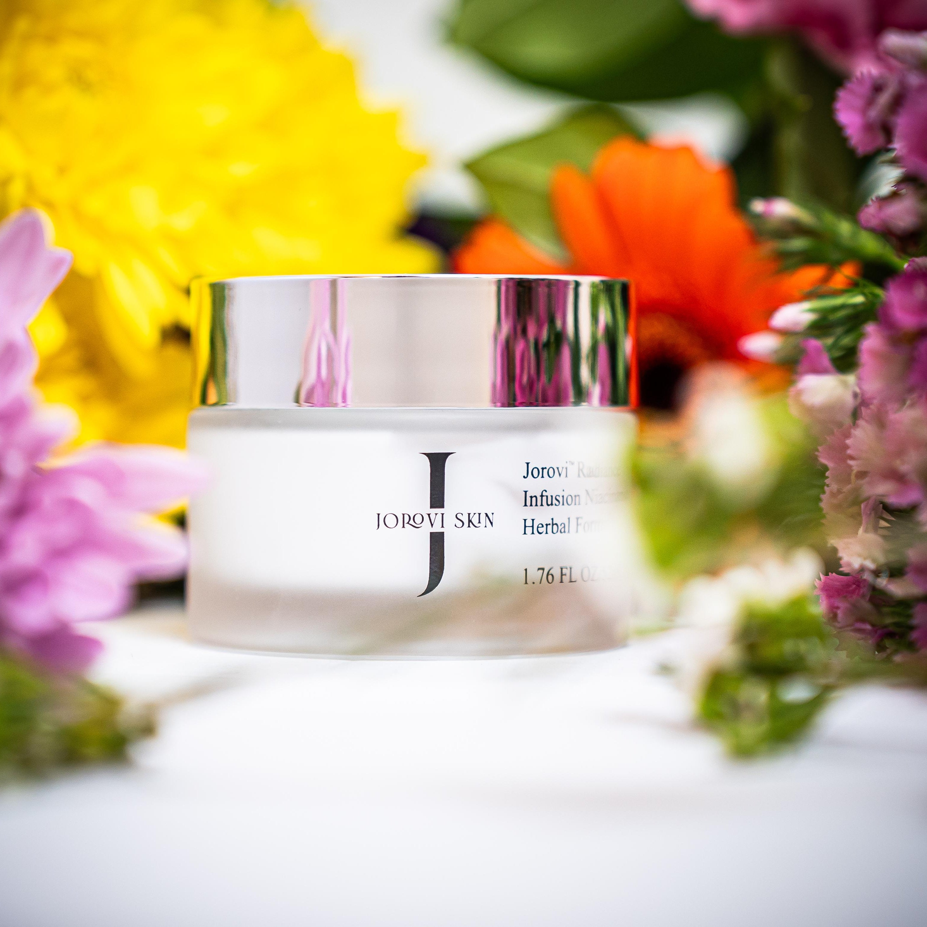 Jar of Jorove Skin cream with flowers in the background jorovi face moisturizer for women and skincare beginners